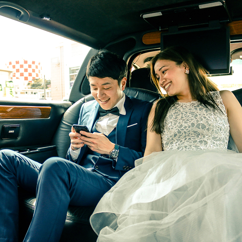 Newlyweds Newlyweds texting in limousine